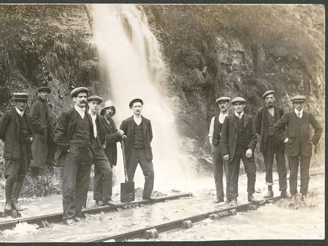 Floodwater gushing down onto the railway track at Bolsover didn't stop these men from having their photo taken before the First World War.