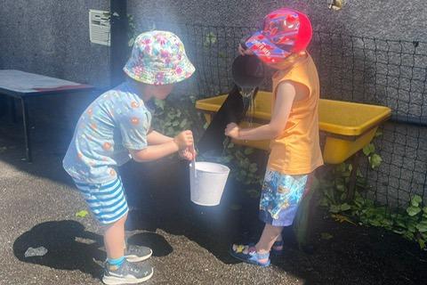 Two friends filling a bucket with water at Burbage Nursery. Pic submitted