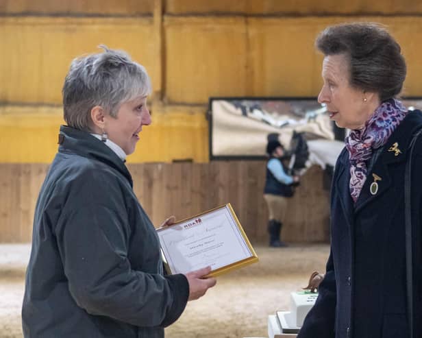 Wendy Howe, left, receiving the award from Princess Anne.