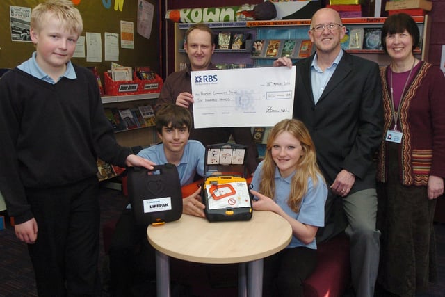 Buxton Community School, defribulator donation. Pupils Sam Butler, Jack Haddon and Abbie Wood with headteacher Deb Hill thank local dentists Dr Tony Cowan and Dr Neil Austin. Photo Jason Chadwick
