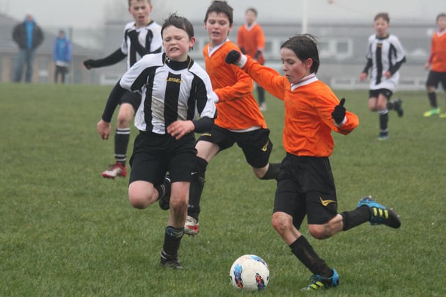 Action from Buxton JFC Cobras U12s v Buxton JFC Vikings U12s on a wet day for football.