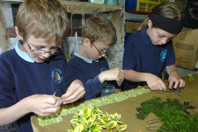 Well dressing has been a rite of passage for generations of village children, like Brandon Townsend, Ben Willis and Charlotte Bonsall from Stoney Middleton Primary School, seen here in 2007. (Photo: Roger Nadal/Sheffield Newspapers Ltd)