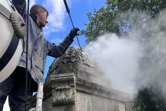 Cleaning off years of old dirt and grime from Chapel war memorial. Photo Steve Davies
