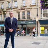 Councillor Damien Greenhalgh, Deputy Leader and Executive Councillor for Regeneration, Tourism and Leisure outside the newly renovated shops in Buxton. Photo High Peak Borough Council