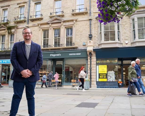 Councillor Damien Greenhalgh, Deputy Leader and Executive Councillor for Regeneration, Tourism and Leisure outside the newly renovated shops in Buxton. Photo High Peak Borough Council