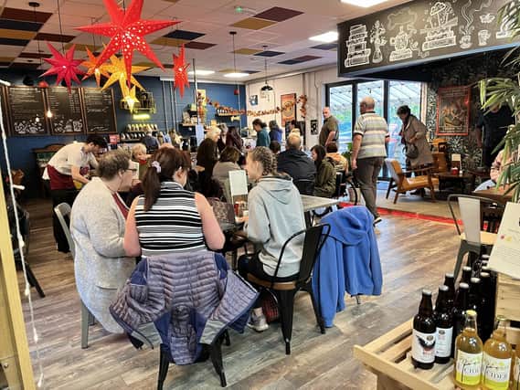 Savouring aromatic coffee and treats at High Peak Bookstore & Café, where literature meets culinary bliss amid the stunning Peak District scenery.
