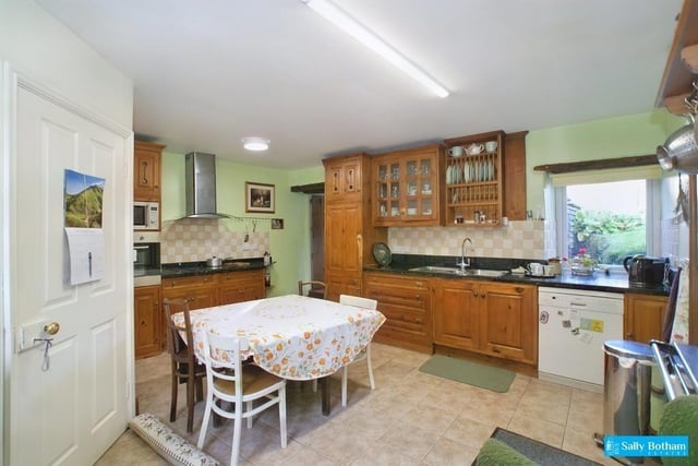 The dining kitchen contains fitted wall and base storage cupboards and a cooking range.