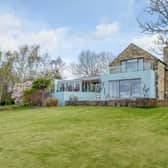 The property, for sale at £1.4m is ultra-modern, but designed to 'blend seamlessly' with the nature around it.