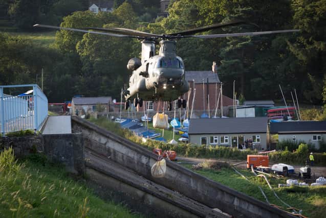RAF Odiham Chinook Force spreads sandbags over dam wall in Whaley Bridge. Photo by Cpl Rob Travis. Copyright MOD Crown.