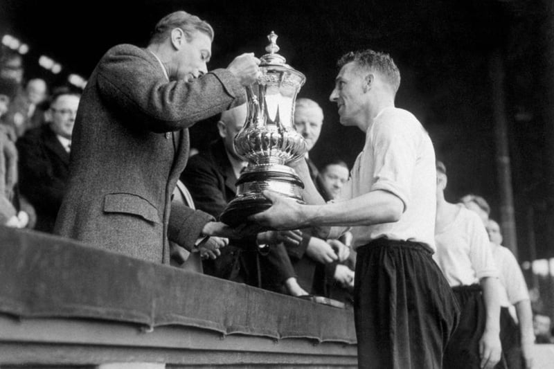 King George VI presents the FA Cup trophy to Jack Nicholas, the captain of Derby County, following the team's 4-1 victory over Charlton Athletic in the FA Cup final at Wembley Stadium on 27th April 1946.