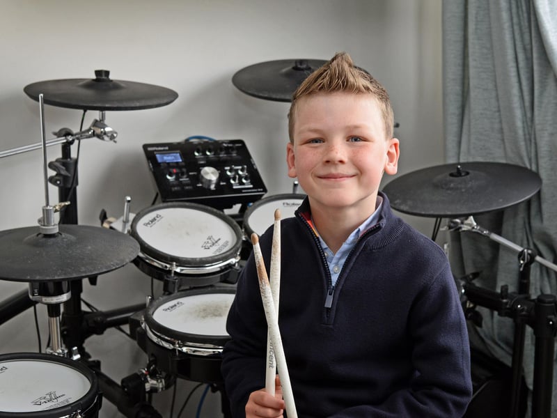 Jared Farmer, aged seven, pictured by his Electric Drums. He has a great talent at such a young age.