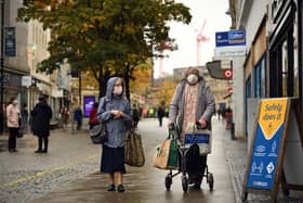 Woman wearing face masks walk along the pavement in the shopping district in central Sheffield (Photo by Oli SCARFF / AFP) (Photo by OLI SCARFF/AFP via Getty Images)