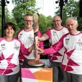 Baton bearers Joanne Lee, Ben Eaton, Ian Sharpe and Peter Danson hold the Queen's Baton during the Birmingham 2022 Queen's Baton Relay on a visit to Buxton. (Photo by Nick England/Getty Images for Birmingham 2022 Queen's Baton Relay)