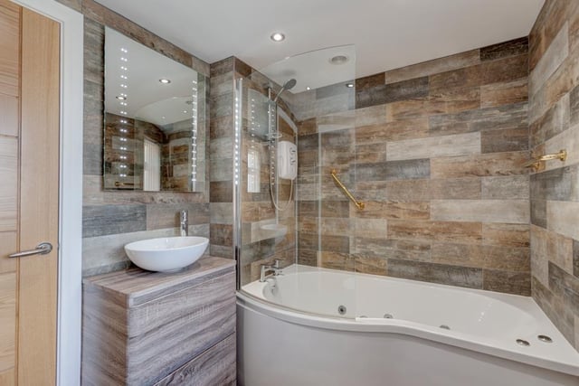 The Nook's bathroom also features full tiling, an illuminated vanity mirror and a chrome heated towel rail. It also has a panelled spa bath with a chrome mixer tap, fitted shower and a glazed screen.