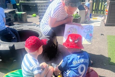 Two friends at Burbage Nursery enjoying a story in the sunshine. Pic submitted