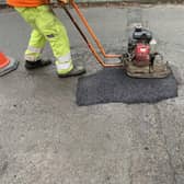 Pictured Is A Derbyshire County Council Worker Completing A Pothole Repair On One Of The County'S Roads.