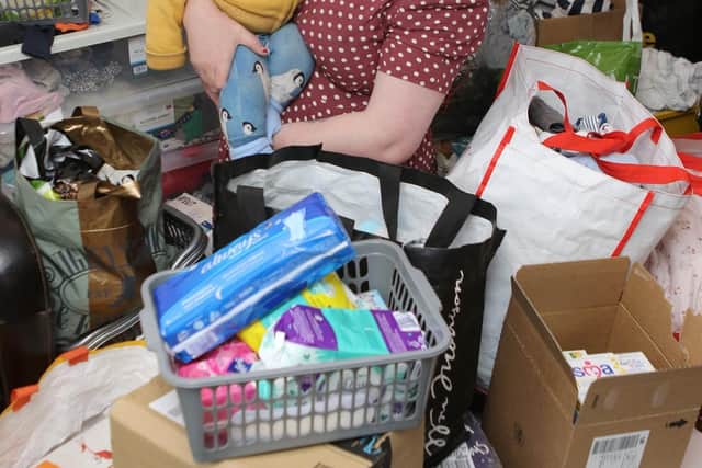 Kirsty Lownds and six month old Rufus with some of the donations that have already come in