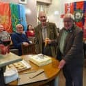 Longstanding club members Reg and Arthur cut the anniversary cake.