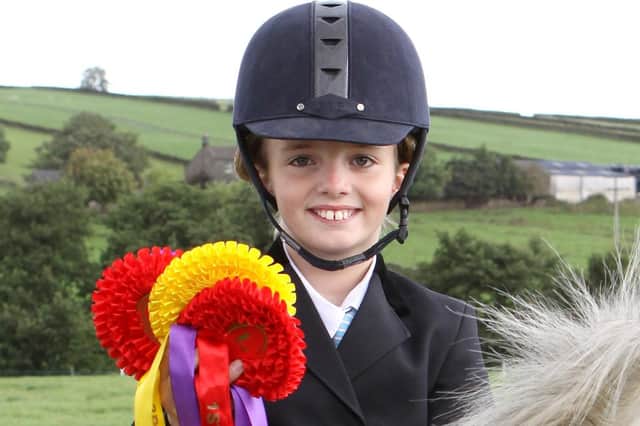 Bethany Smith with a handful of rosettes from the 2011 gymkhana. Photo Jason Chadwick