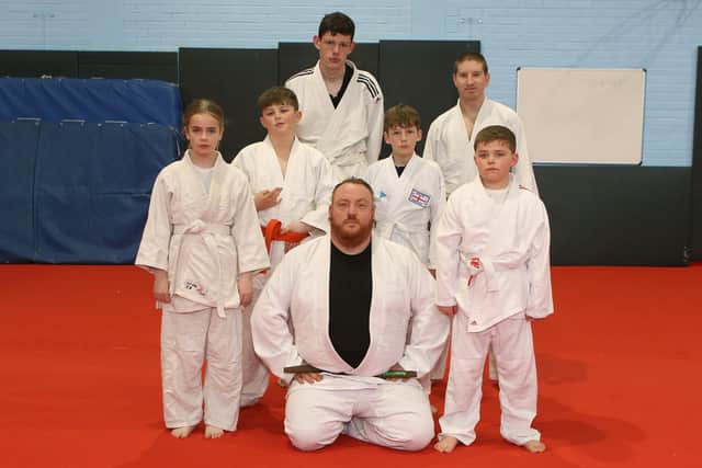 Adam with a selection of students of different ages at Buxton Judo. Photo Jason Chadwick