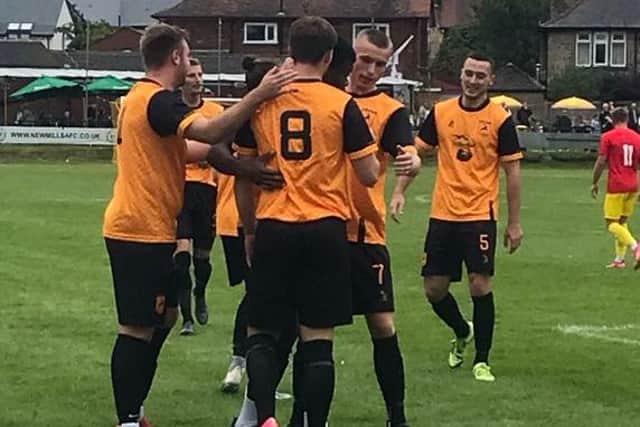 New Mills celebrate scoring against Stockport Town. Photo: New Mills FC.