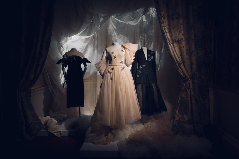 Beautiful gowns in a stately bedroom.