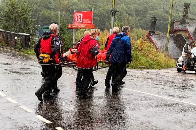 Buxton Mountain Rescue Team carrying Denis away for medical checks