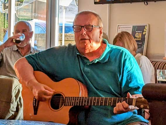 Nigel Barrow getting lost in the performance at Mottram CC, Unplugged And Acoustic group. Photo Ben Wild