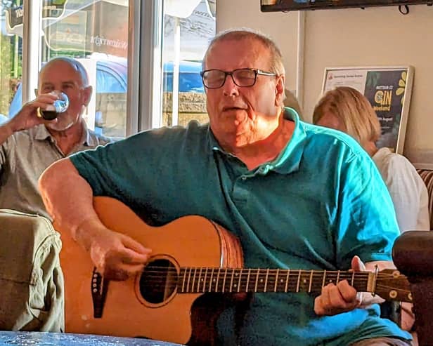 Nigel Barrow getting lost in the performance at Mottram CC, Unplugged And Acoustic group. Photo Ben Wild