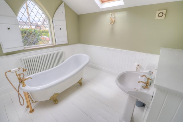 A stunning roll top bath takes pride of place in the centre of the refitted bathroom.