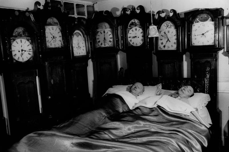 Mr and Mrs Charles Bromley, of Belper, at home in 1955 with part of their collection of 109 grandfather clocks.