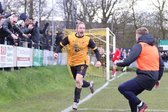 Joe Bevan celebrates New Mills' dramatic late winner.