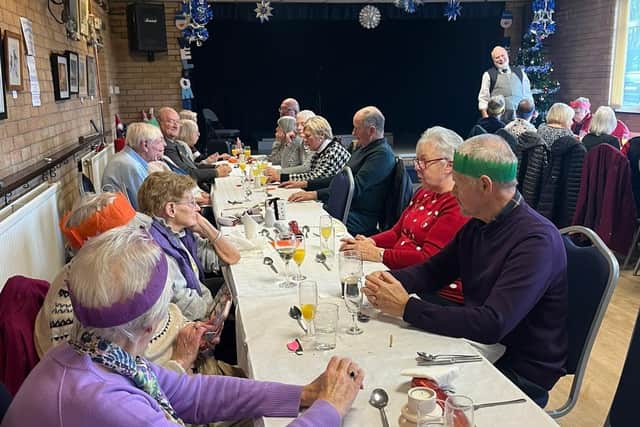 Some of the 72 residents who enjoyed a free Christmas meal in Dove Holes Community centre. Photo submitted