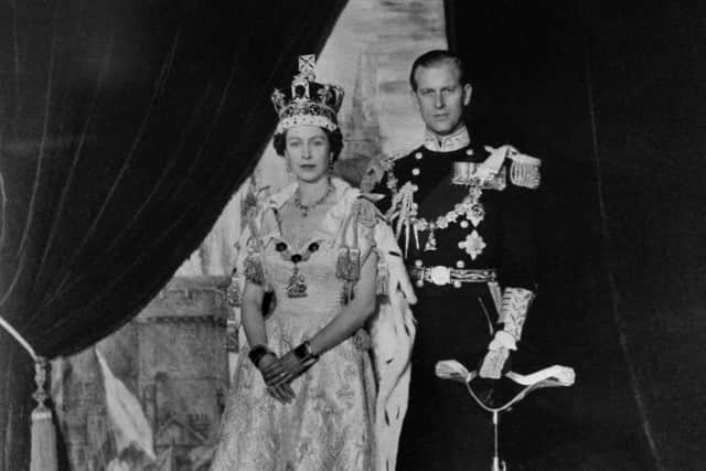 Queen Elizabeth II and Prince Philip pose after the Queen's Coronation on June 2 1953 in Buckingham Palace. (Photo by - / AFP) (Photo by -/-/AFP via Getty Images)