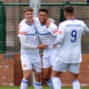 Buxton's Warren Clarke (centre) is congratulated after opening the scoring against Bamber Bridge on Saturday. Photo by Brian Eyre.