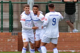 Buxton's Warren Clarke (centre) is congratulated after opening the scoring against Bamber Bridge on Saturday. Photo by Brian Eyre.