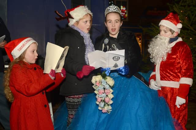 Queen Katelyn and her retinue singing a carol at the 2013 lights switch on. Photo Jason Chadwick