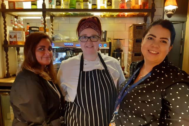 Landlady Hannah Bradley, right, transferred from The Admiral Rodney in Loxley, Sheffield, last May. She says that was busy but the Castle in Castleton is on a 'different level'. With, from left: Catherine Khan and Lauren Crawford.