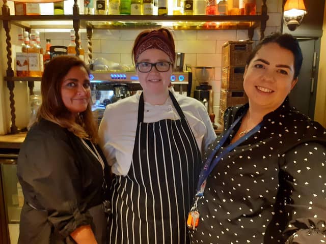 Landlady Hannah Bradley, right, transferred from The Admiral Rodney in Loxley, Sheffield, last May. She says that was busy but the Castle in Castleton is on a 'different level'. With, from left: Catherine Khan and Lauren Crawford.