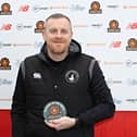 Craig Elliott with his February Manager of the Month award.
