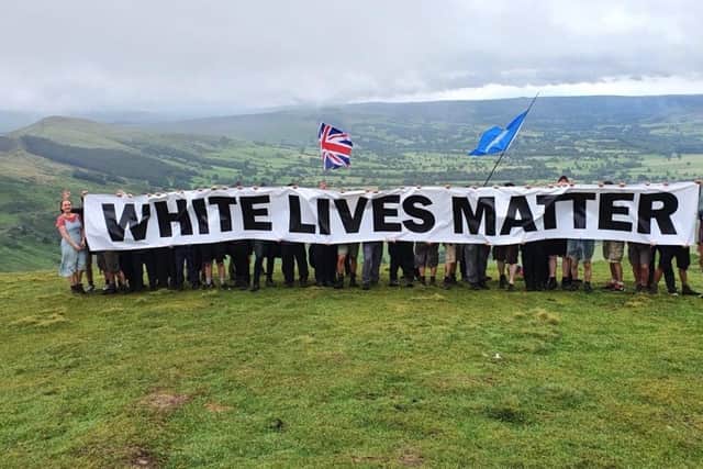 The group unfurl the banner on Mam Tor - photo by Patriotic Alternative