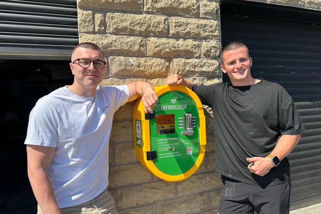 Callen Deighan and Charlie Edwards of High Peak Comps, pictured with their own defibrillator in Dove Holes, one of four in the town.