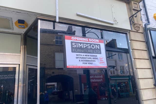 A sign for Simpson Furniture on the window of the former M&S building in Buxton