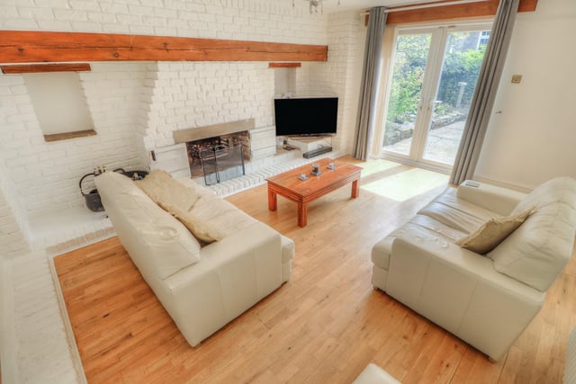 The lounge has a brick fireplace, heath and mantle and French doors leading to the garden.