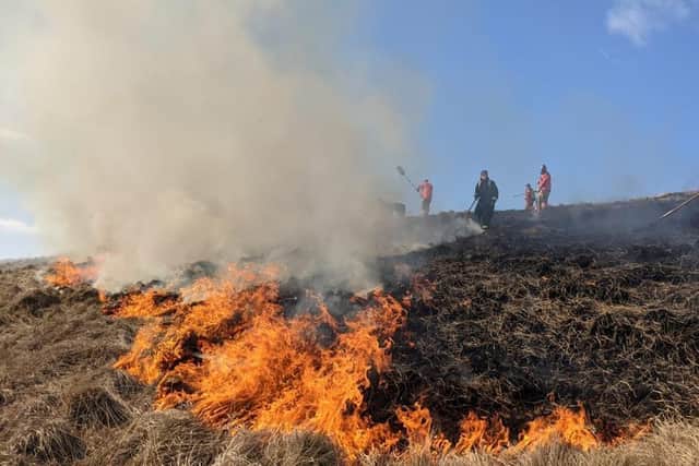 Firefighters tackling a large moorland fire at Rushup Edge.