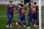 Lionel Messi celebrates with teammates after scoring for Barcelona against Real Betis. (Photo by Eric Alonso/Getty Images)