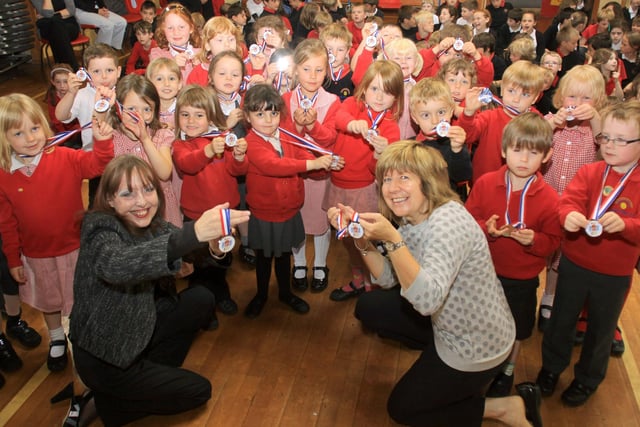 Janet Carter and Gwyn Bowers of New Mills Town Council handing out Jubilee Medals at New Mills Primary School.