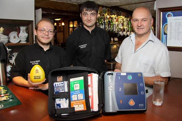 Landlord Steve Nagy and staff Jim Frodsham and Ben Gager training to use a defibrillator at the George Hotel pictured in 2012