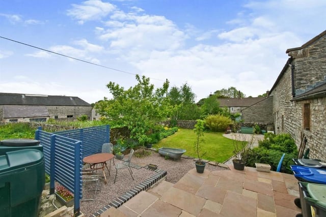 The raised Indian sandstone patio with the screened-off gravelled area for alfresco dining.