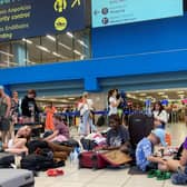 Tourists wait in the airport's departure hall as evacuations are underway due to wildfires, on the Greek island of Rhodes on July 23, 2023.